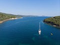 White sailing ship yacht at sea in shallow water near shore. Aerial drone view to sailboat Royalty Free Stock Photo