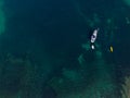 White sailing ship yacht at sea in shallow water near shore. Aerial drone view to sailboat. View from above Royalty Free Stock Photo