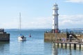 A white sailing yacht leaves Newhaven harbour,into the Firth of Forth river