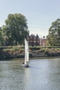 A white sails sailboat maneuvers on the River Thames near Richmond, London Royalty Free Stock Photo