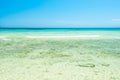 White sand beach and clear sea water under blue sky Royalty Free Stock Photo