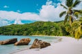 White sand beach, coconut palms and blue lagoon of tropical island, Anse Takamaka beach, Seychelles Royalty Free Stock Photo