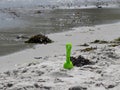 White sand beach, lime green shovel