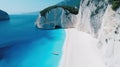 White Sand Beach Of Mediterranean Shoreline. Green Grass Covered Cliff Washed By The Turquoise Transparent Sea Water