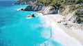 White Sand Beach Of Mediterranean Shoreline. Green Grass Covered Cliff Washed By The Turquoise Transparent Sea Water