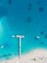 White sand beach and port pier with transparent blue and turquoise water, aerial top down view from drone on tropical island in Royalty Free Stock Photo