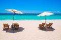 White sand beach with umbrellas and chairs Royalty Free Stock Photo