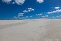 White sand and clouds against a blue sky Royalty Free Stock Photo