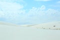 White sand dune on a day with blue skies and clouds Royalty Free Stock Photo