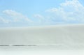 White sand dune with wind formed ripples on a day with blue skies Royalty Free Stock Photo