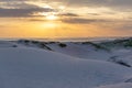 White sand dunes of Birubi beach at sunset.