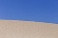 White sand dunes on summertime in Portugal, blue sky background. Holidays and relax concept