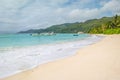 Palm trees, white sand and turquoise sea at Fairyland Beach, Seychelles Africa.