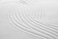 White sand with pattern as background, closeup. Concept of zen and harmony Royalty Free Stock Photo