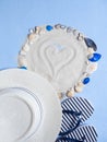 White sand and seashells in a circle, hat and Slippers on a blue background. Concept of rest on the sea. Creative Royalty Free Stock Photo