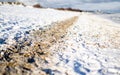 White sand and snowmixed footpath by the coast line
