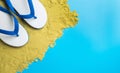 White Sandals on brown sand on blue Royalty Free Stock Photo