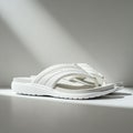 White sandals featuring a textured strap design and contoured footbed, placed Royalty Free Stock Photo