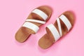 The white sandals on pink background close-up, top view. Royalty Free Stock Photo