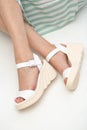 White sandals with platform on woman`s feet