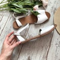 White sandals on a wooden background Royalty Free Stock Photo