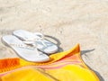 White sandals on beach with towel Royalty Free Stock Photo