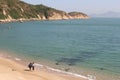 Couple at white sandy beach at Cheung Chau Island, Hongkong Royalty Free Stock Photo