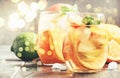 White sangria with dry wine, citrus, fruit and ice, gray bar counter background, bokeh party lights, selective focus Royalty Free Stock Photo