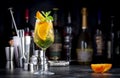 White sangria summer alcoholic drink with white spanish wine, peach, orange, lime and ice. Black bar counter background, steel bar Royalty Free Stock Photo