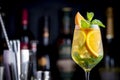 White sangria summer alcoholic drink with white spanish wine, peach, orange, lime and ice. Black bar counter background, steel bar Royalty Free Stock Photo