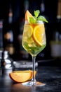 White sangria summer alcoholic drink with white spanish wine, peach, orange, lime and ice. Black bar counter background, steel bar Royalty Free Stock Photo