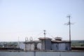 White satellite dishes with two converters mounted on residental building rooftop concrete wall. Satellite television