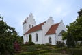 White scandinavian church with a tower and stepped gables