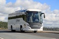 White Scania Touring Bus on the Road at Summer