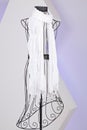 white scarf woven with fringes on mannequin