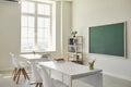 White school classroom interior. Bright lassroom with windows tables chair green board Royalty Free Stock Photo