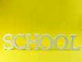 School wooden alphabet letters on yellow background Royalty Free Stock Photo