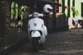 White scooter on the street paving of the old Riga