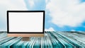 White screen computer on wooden table, blurred sky background ,empty space for text and image,use advertising media,montage for