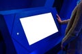 White screen concept - woman looking at blank interactive white display kiosk Royalty Free Stock Photo