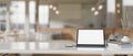 A white-screen digital tablet mockup on a white tabletop in a modern beautiful coffee shop Royalty Free Stock Photo