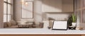 A white-screen digital tablet mockup on a white tabletop in a modern living room Royalty Free Stock Photo