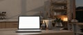 A white-screen laptop computer on a kitchen island in a modern kitchen at night Royalty Free Stock Photo