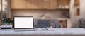 A white-screen laptop computer and stationery on a white marble table in a modern living room Royalty Free Stock Photo