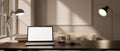A white screen laptop mockup on a dark hardwood table in a modern home office or living room Royalty Free Stock Photo