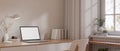 A laptop on a minimal wooden desk with accessories in a beautiful cosy minimalist home office room Royalty Free Stock Photo