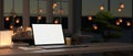 A white-screen laptop mockup on an office desk in a modern dark office room at night. close-up image Royalty Free Stock Photo