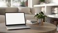 A white-screen laptop mockup on a wooden coffee table in a modern bright living room Royalty Free Stock Photo