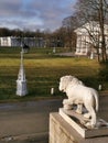 A white sculpture of a lion at the entrance to the Elaginoostrovsky Palace against the background of a beautiful lantern,