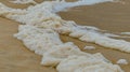 A white sea foam on the beach in macro Royalty Free Stock Photo